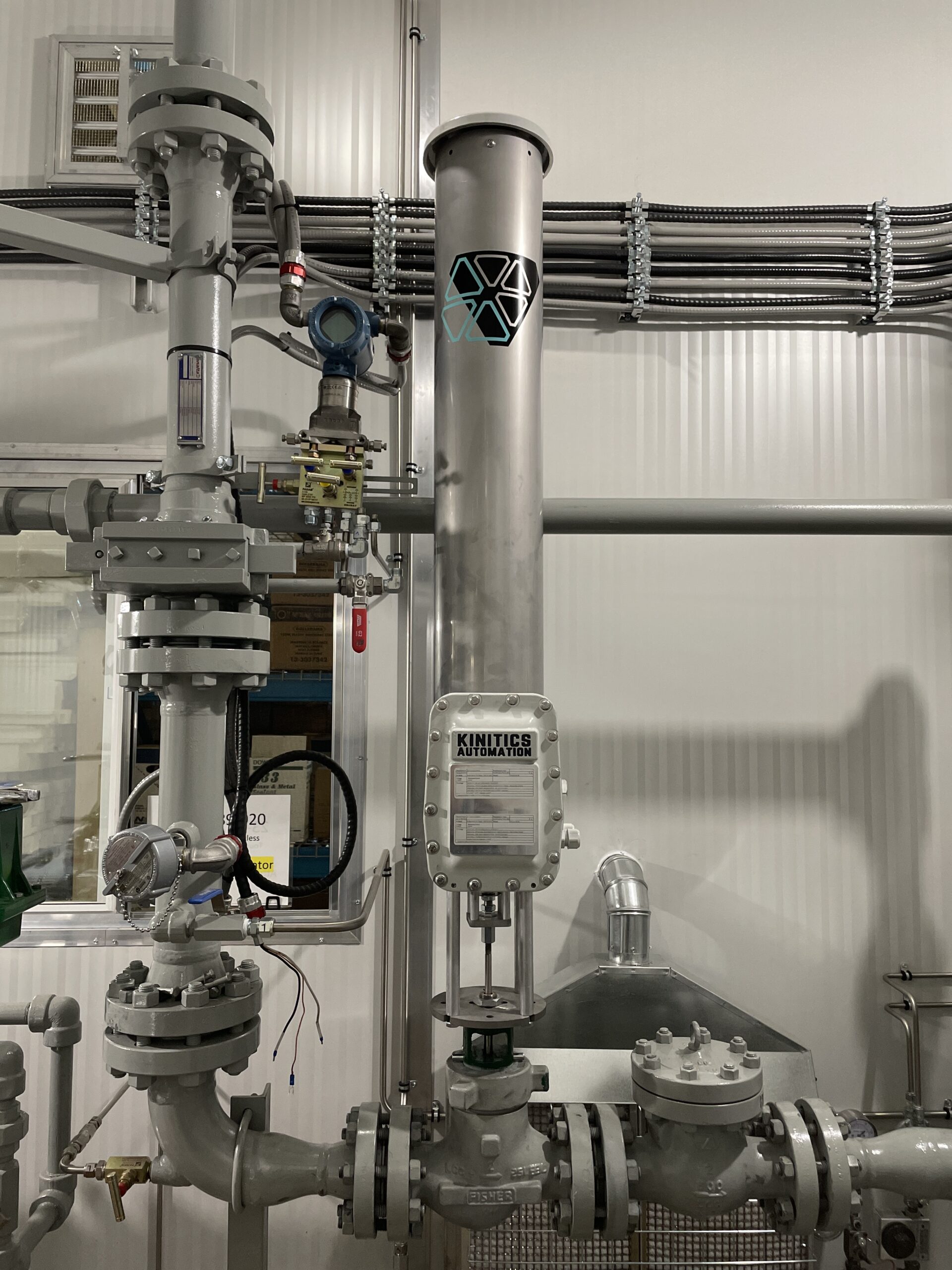 A Kinitics KVA38 valve actuator, with its branded stainless tube, installed on process skid piping in a facility